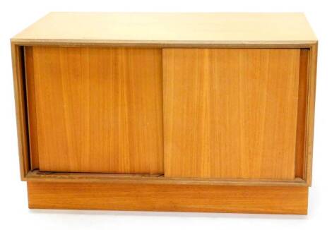 A G-Plan type teak TV cabinet, with two plain doors on a plinth base, 48cm high, 76cm wide, (AF).