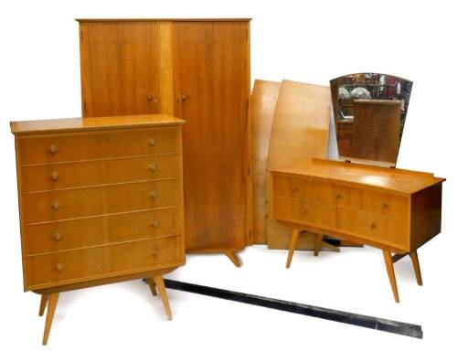 A 1960s/ 70s walnut and burr wood retro bedroom suite, comprising two door wardrobe, chest of five drawers on square tapering legs, matching concave dressing table and double bedhead and foot.