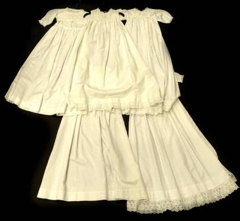 Five christening gowns, one with embroidered collar, 89cm long.