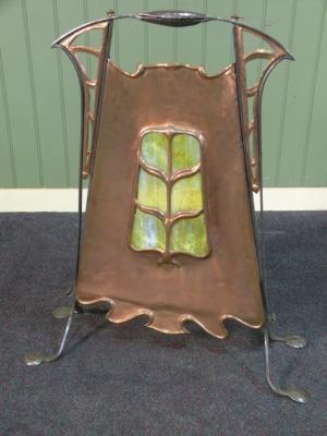 A copper and iron fire screen in Art Nouveau inset with a mottled