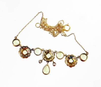 A diamond, seed pearl and peridot cluster necklace, the pendant section set with three clusters set with central square cut peridot and surrounded by grey coloured seed pearls, the central cluster with a diamond to each end, and a pear cut peridot drop, t - 3