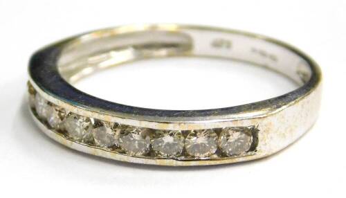 A 9ct white gold half hoop eternity ring, set with various white stones, in channel setting, ring size N½, 1.7g all in.