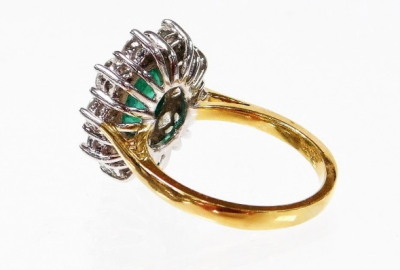 An 18ct gold emerald and diamond cluster ring, with oval cut emerald 8.6mm x 6.6mm x 3.8mm, totalling approx 1.60cts, in claw setting, surrounded by ten round brilliant cut diamonds, each 3.2mm x 3.2mm x 2.8mm, totalling approx 1.50cts, in white fold bask - 2