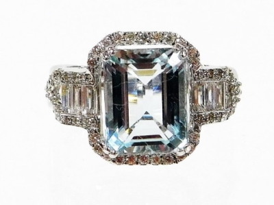 An aquamarine and diamond dress ring, with rectangular cut aquamarine, in four claw white gold setting, totalling 3.95cts, surrounded by round brilliant cut diamonds, approx 0.29cts, with baguette cut diamond sides, totalling approx 0.27cts, with twist op