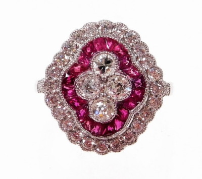 A Victorian style ruby and diamond cluster ring, with four central round brilliant cut diamonds, with outer halo of baguette cut rubies, and a halo of round brilliant cut diamonds, with diamond set shoulders, white metal, unmarked platinum, ring size O, 6