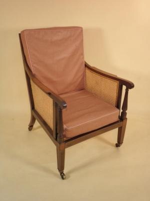 A late 19thC Sheraton Revival mahogany and satinwood bergere armchair