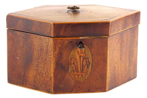 A George III mahogany and boxwood strung tea caddy, of elongated hexagonal form, the hinged lid with a marquetry oval enclosing two lidded divisions, the front with an oval marquetry fleur de lys, (AF) 13cm high, 24cm wide.