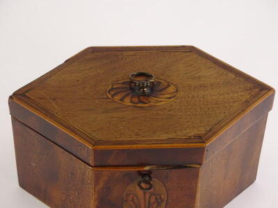 A George III mahogany and boxwood strung tea caddy, of elongated hexagonal form, the hinged lid with a marquetry oval enclosing two lidded divisions, the front with an oval marquetry fleur de lys, (AF) 13cm high, 24cm wide. - 2