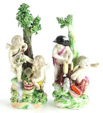 A pair of late 18thC Derby porcelain figures, each modelled in the form of putti with fish and knife sharpening etc., (AF), 20.5cm high.