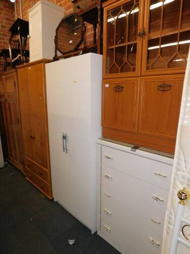 A white melamine wardrobe, chest of drawers, bedside cabinet and a teak effect glazed cabinet. (4)