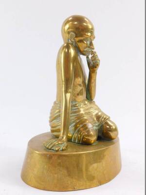 A brass figure of Mahatma Gandhi, modelled kneeling on an oval base, 20cm high. - 2