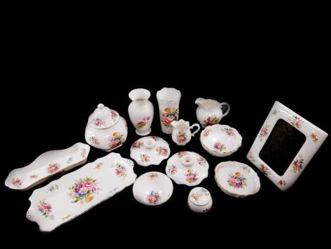 A group of Aynsley porcelain decorated in the Howard Sprays pattern, including a pair of candlesticks, photograph frame, cream jug and sugar bowl, jar and cover, dishes, bowls etc. (a quantity)