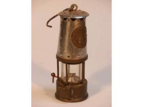 A vintage miners lamp by The Protector Lamp and Lighting Co Ltd