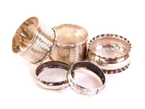 A pair of George V silver napkin rings, with engine turned decoration, Birmingham 1930, further pair of silver napkin rings, and another, total weight 1.13oz. (5)