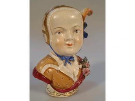 An early 20thC Dresden porcelain bust of a young female wearing a floral