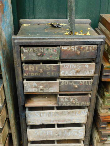 A pine blanket box, converted to a chest with an arrangement of seven short and three long drawers, named for various nuts, bolts, pins, etc., 90cm high, 47cm wide, 41cm deep.