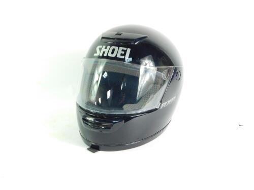 A Shoei RX-R black motorcycle helmet.