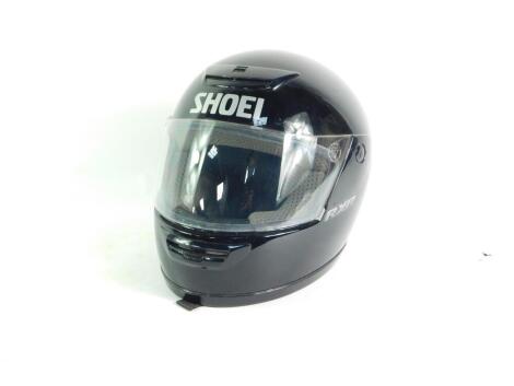 A Shoei RX-R black motorcycle helmet.