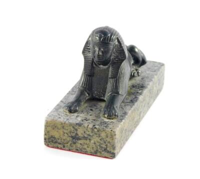 An Armstrong Siddeley vintage car radiator cap mascot, modelled as a sphynx, in recumbent pose, raised on a marble base, 12.5cm wide.