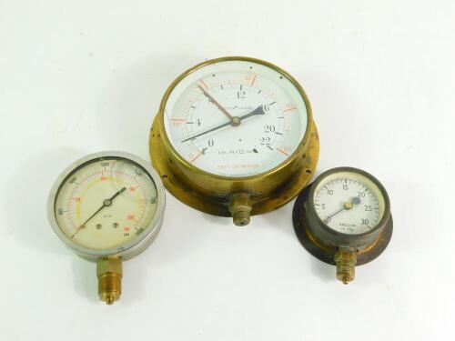 A Tomey brass cased circular altitude gauge, 18cm diameter., a Bar and PSI gauge, and a vacuum in. HG. gauge.(3)