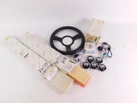 A Mountney steering wheel, together with Jaguar X Type parts including pollen filter, diesel filter, air filter, HID burner bulb, boot lid release switch and four wheel badges, some boxed. (a quantity)