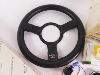 A Mountney steering wheel, together with Jaguar X Type parts including pollen filter, diesel filter, air filter, HID burner bulb, boot lid release switch and four wheel badges, some boxed. (a quantity) - 7