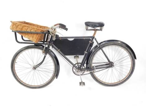 A vintage mid 20thC Phillips tradesman's bicycle, black frame, with basket.