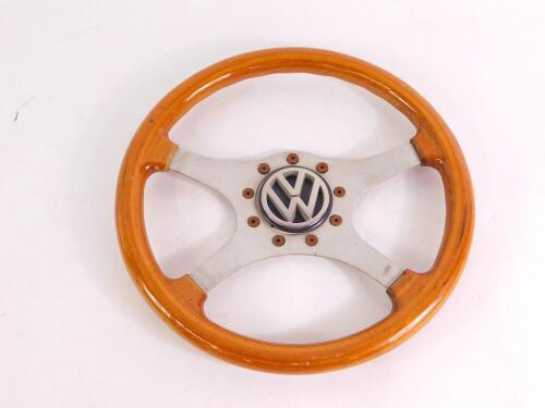 A Raid four spoke steering wheel, wooden bound, with a VW cap, 35.5cm diameter.