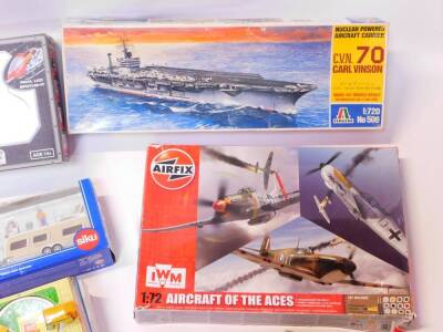 Three Crayola Goodyear Collector Series coin banks, a Bladez Toys Salvation Gyro., Italeri Nuclear Powered Aircraft Carrier CVN70 Carl Vinson., Siku Super Car with Caravan., and further toys and kits. (a quantity) - 5