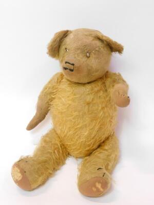 An early 20thC straw filled golden mohair Teddy Bear, 52cm high. (AF)