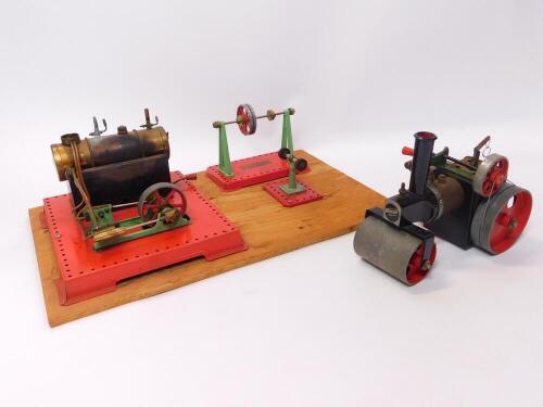 A Mamod steam pump, steam roller, etc., wooden base mounted.