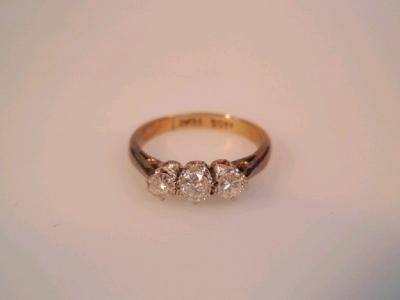 A three stone diamond ring of total mounted estimated weight 0.30ct set