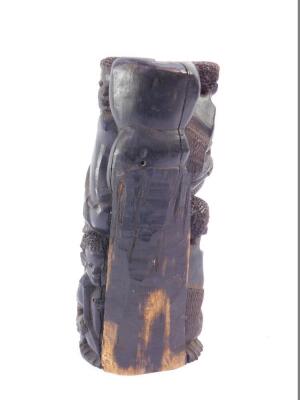 A Northern Mozambique Makonde ebony family tree carving, depicting two rows of eight crouching and embracing figures, 21.5cm high. - 2