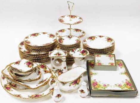 A Royal Albert Old Country Roses pattern part dinner service, comprising twelve cake plates, cake stand, eight soup bowls, eight side plates, eight small bowls, salt and pepper, gravy boat, vase, bud vase, mantel clock, four trinket dishes, a rectangular 