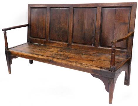 An 18thC elm, oak and pine settle, with scroll carved sides, formed seat, held with metal fasteners, the legs cut, 105cm high, 172cm wide, 50cm deep.