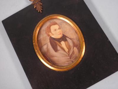 A 19thC miniature on ivory of a gentleman with red hair and glasses wearing