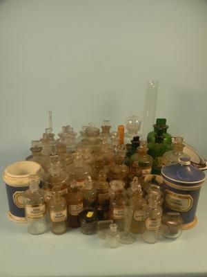 A large quantity of 19thC and later ceramic and glass chemists bottles with stoppers etc