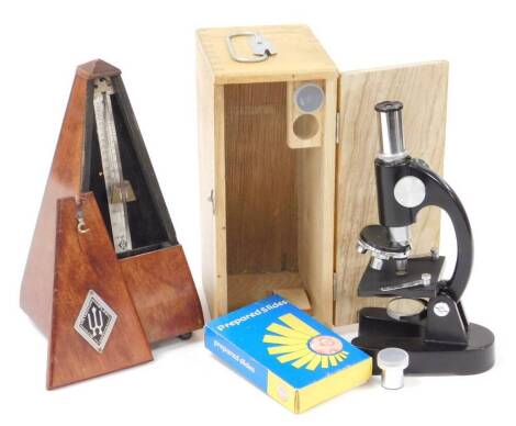 A 20thC Maelzel metronome, 24cm high, and a student's microscope in light wood case, with visible dove tails. (2)