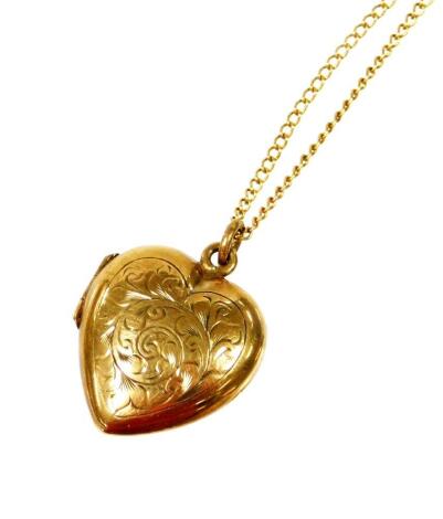 A 9ct gold pendant and chain, the 9ct gold heart shaped locket pendant florally engraved, on a fine link chain, 5.1g all in.