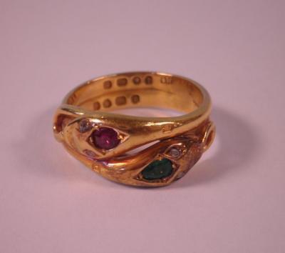 A George V 18 carat gold ring in the form of two entwined snakes set with a ruby