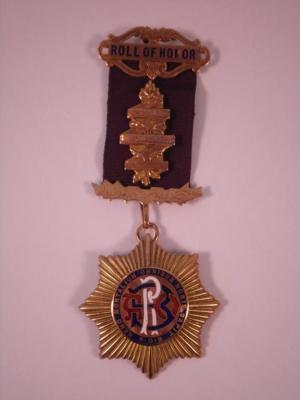 A 9 carat gold and enamelled masonic roll of honour medal presented to