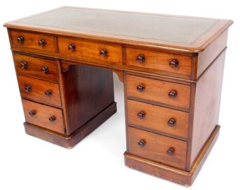 A 19thC mahogany twin pedestal desk, with a one piece stencilled leather top, raised above three frieze drawers and six pedestal drawers, on plinth base, 78cm high, 122cm wide, 59cm deep.