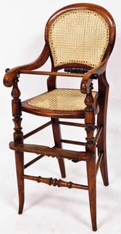 A late Victorian child's highchair, with bergere back and seat and front foot rest on sabre supports, 95cm high.