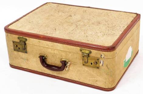 A vintage pressed cream leather finish travel case, with brass lock and brown leather extremities with visible stitching and partial labels, 20cm high, 55cm wide, 45cm deep.