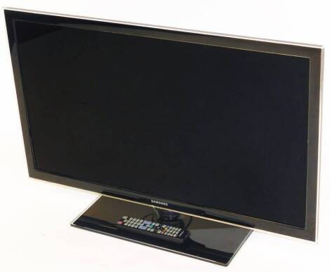A Samsung 37" colour television, in black trim, with remote control and wire. UE37D5000.