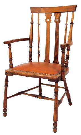 A walnut elbow chair, with shield back, and mother of pearl inlay, on bobbin turned legs with H stretcher and faux leather brown seat, 112cm high, 56cm wide, 49cm deep.