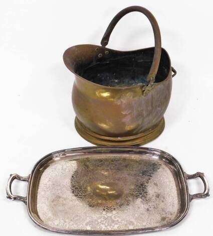 A copper coal helmet, and a silver plated serving tray. (2)