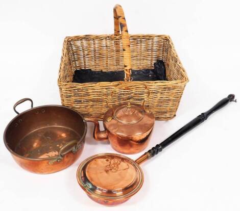 An early 20thC copper kettle, with fixed handle, 35cm high, copper warming pan, circular dish and a wicker basket. (a quantity)