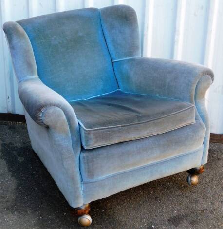 A late Victorian wing back armchair, with turned front legs, in later blue material, 95cm wide.