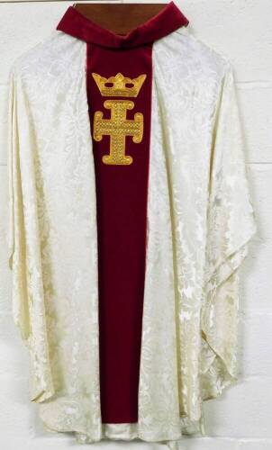 An ecclesiastical vestment robe, with crown and cross motif on a red ground, with white body, 133cm high, size unknown.